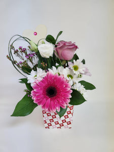 Arrangement à la Française avec gerbera, roses et fleurs variées dans une boîte en carton pour la Saint-Valentin